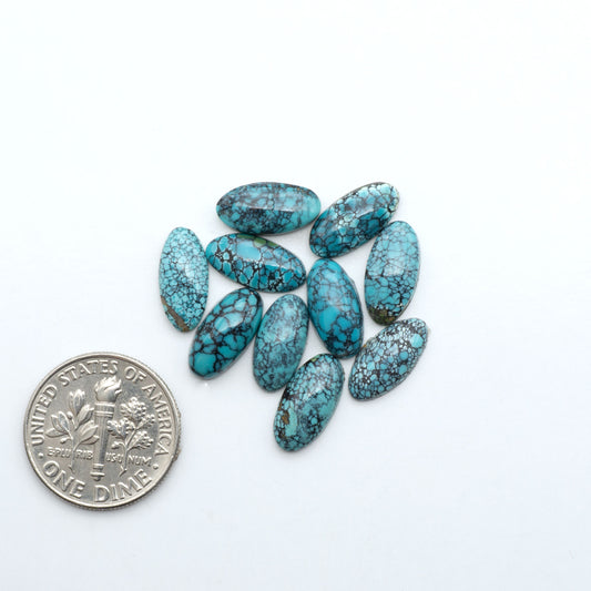 Hubei Cloud Mountain Turquoise cabochons, blue and green color with black matrix, polished stones on a white background with a US dime for scale