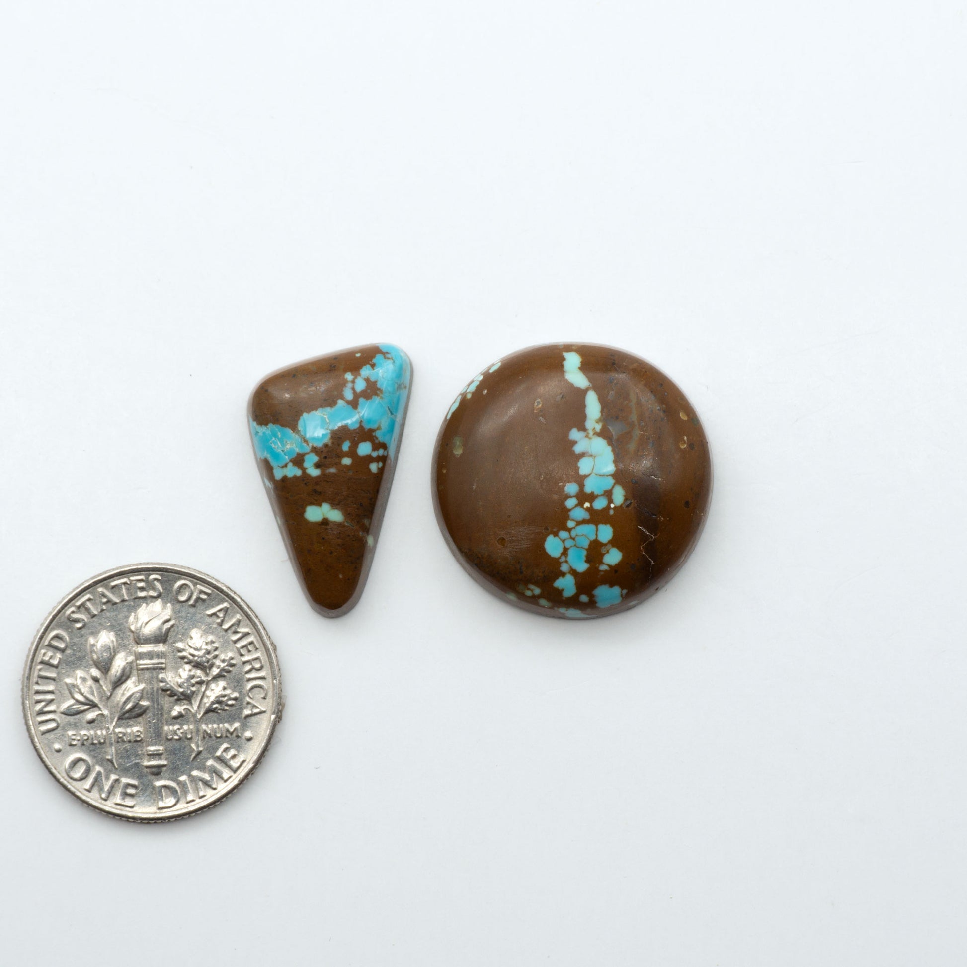 Number 8 Turquoise cabochons, blue and green color with brown matrix, polished stones on a white background, with a US dime for scale
