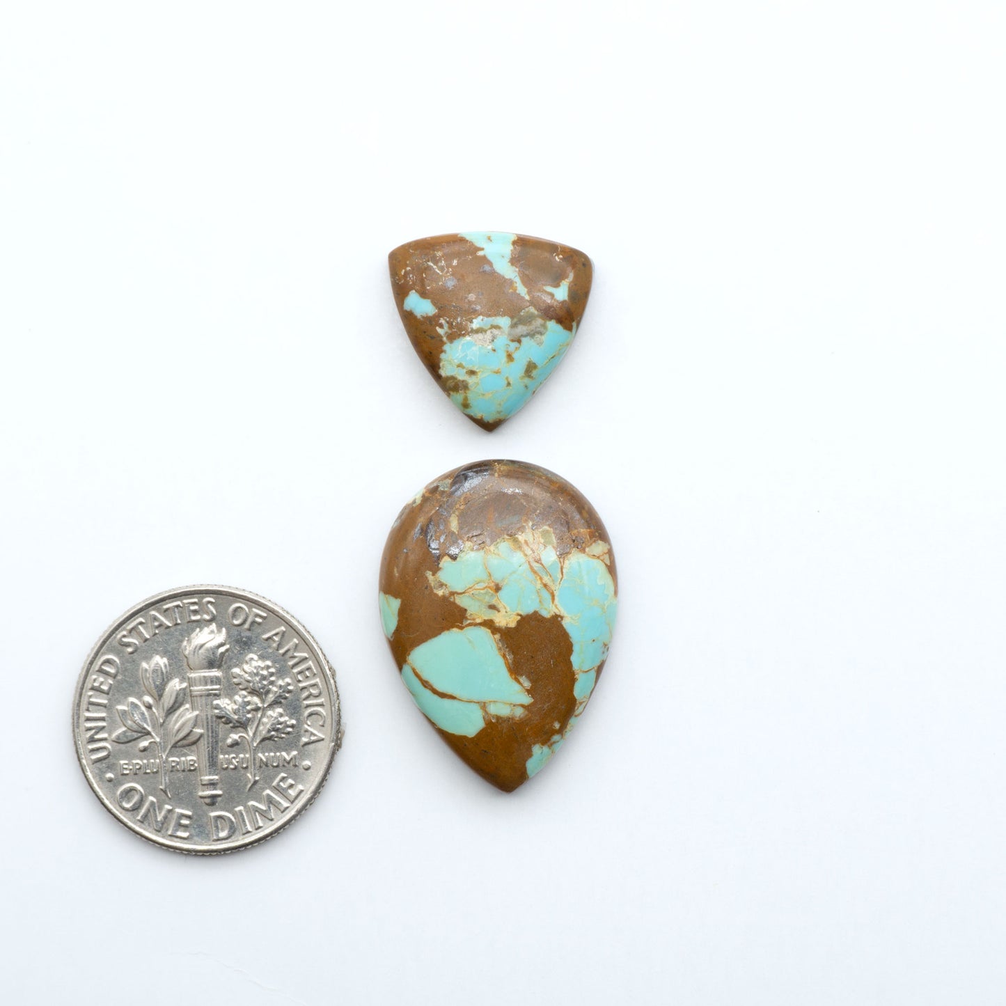 Number 8 Turquoise cabochons, blue and green color with brown matrix, polished stones on a white background, with a US dime for scale