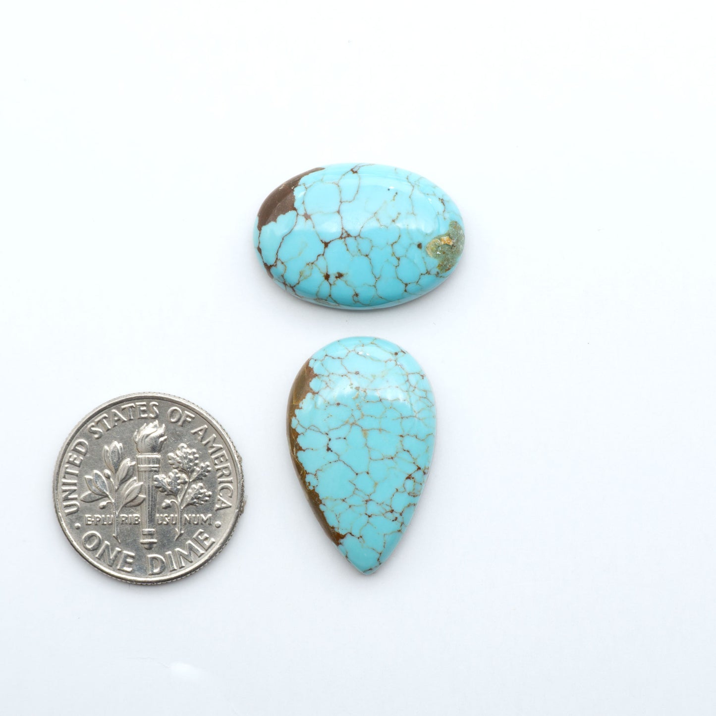 Number 8 Turquoise cabochons, blue and green color with brown matrix, polished stones on a white background, with a US dime for scale