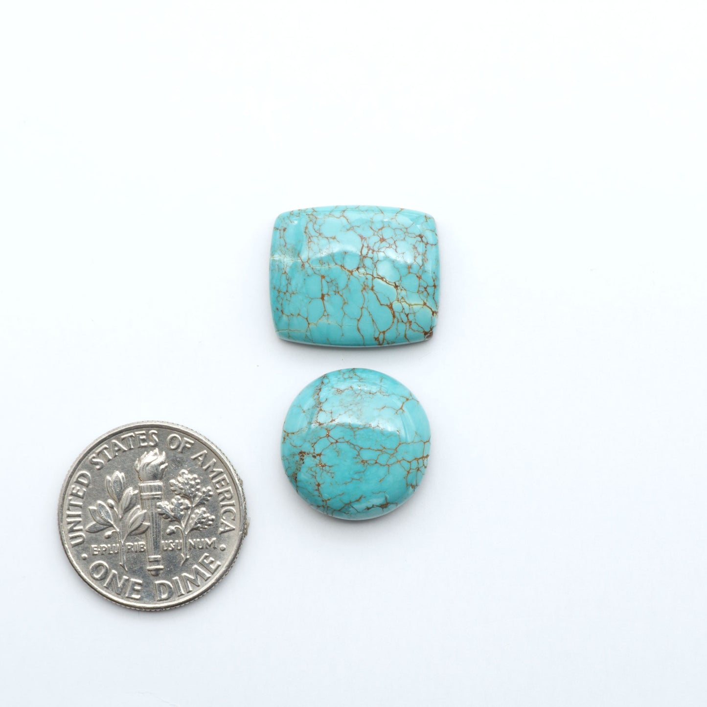Number 8 Turquoise cabochons, blue and green color with brown matrix, polished stones on a white background, with a US dime for scale