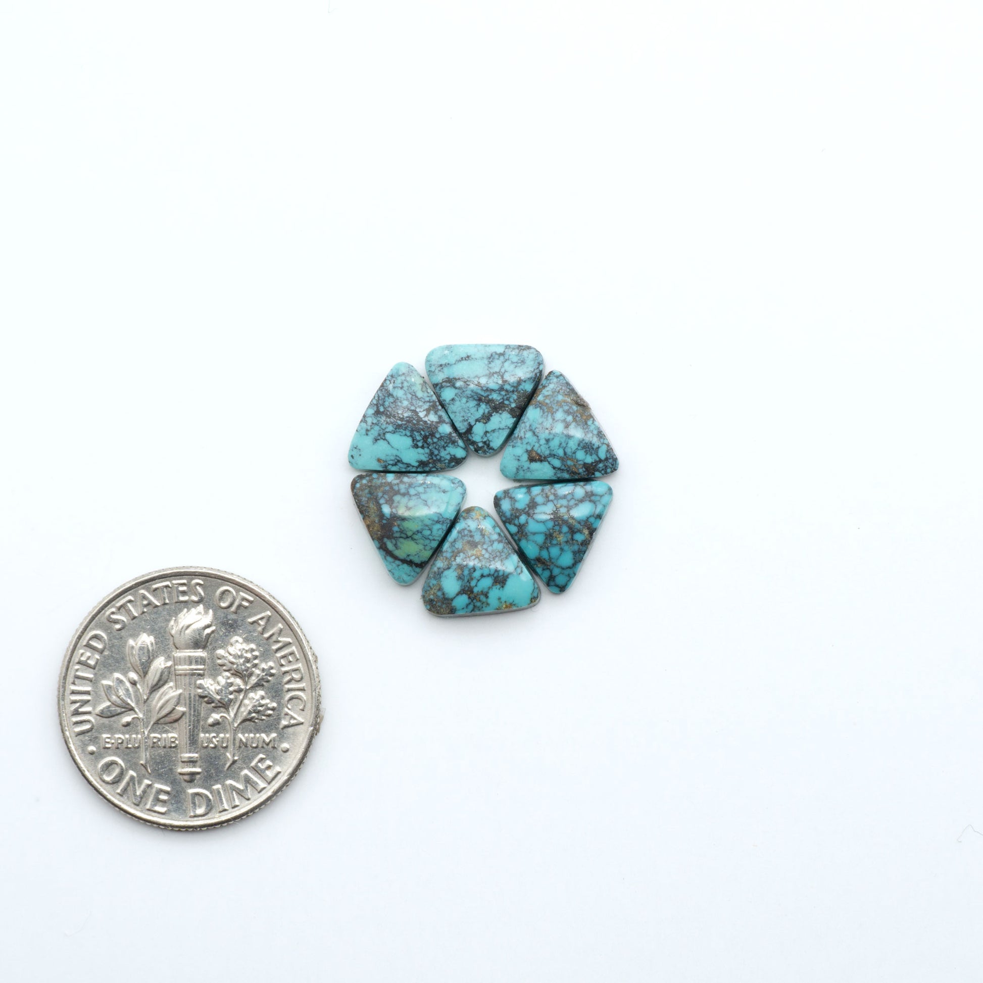 Hubei Cloud Mountain Turquoise cabochons, blue and green color with black matrix, polished stones on a white background, with a US dime for scale