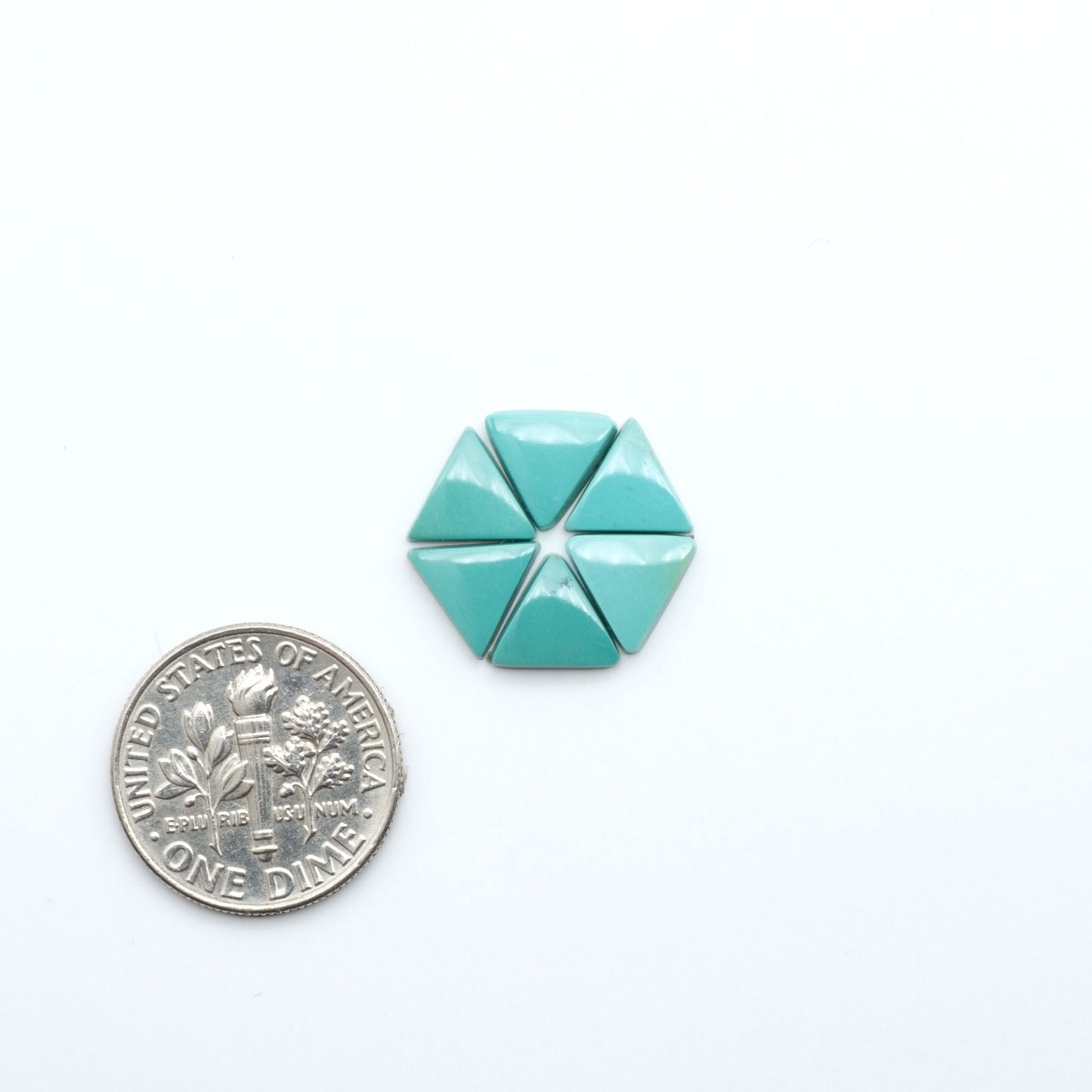 Hubei Cloud Mountain Turquoise cabochons, blue and green color with black matrix, polished stones on a white background, with a US dime for scale