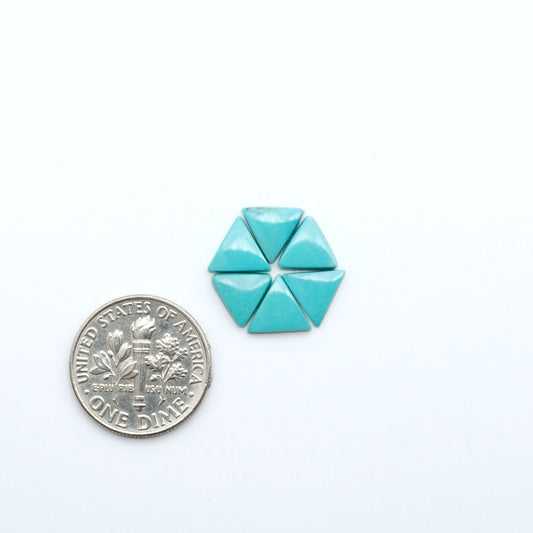 Hubei Cloud Mountain Turquoise cabochons, blue and green color with black matrix, polished stones on a white background, with a US dime for scale