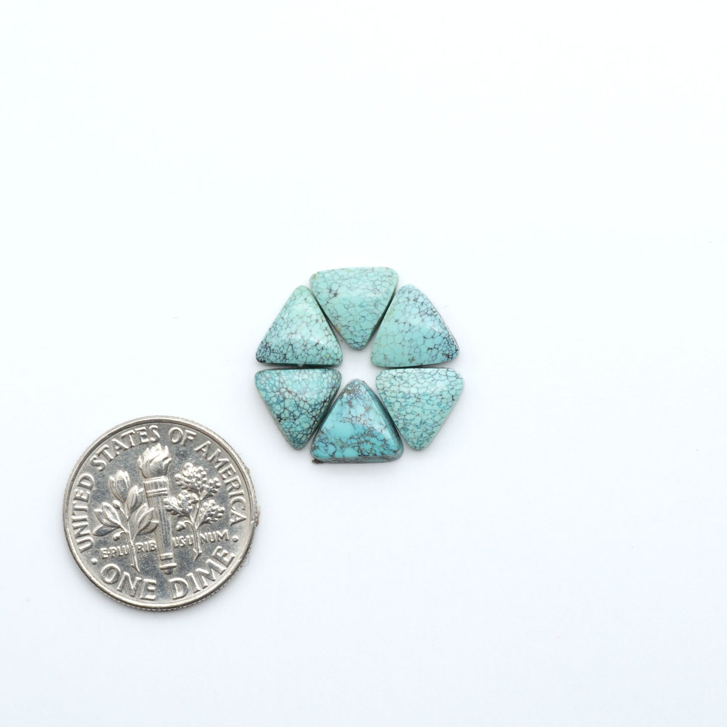 Hubei Cloud Mountain Turquoise cabochons, blue and green color with black matrix, polished stones on a white background, with a US dime for scale