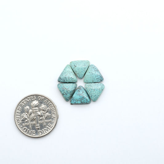 Hubei Cloud Mountain Turquoise cabochons, blue and green color with black matrix, polished stones on a white background, with a US dime for scale