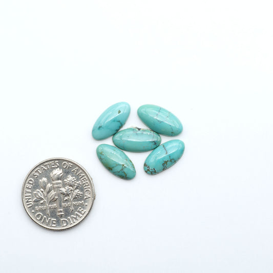 Hubei Cloud Mountain Turquoise cabochons, blue and green color with black matrix, polished stones on a white background, with a US dime for scale