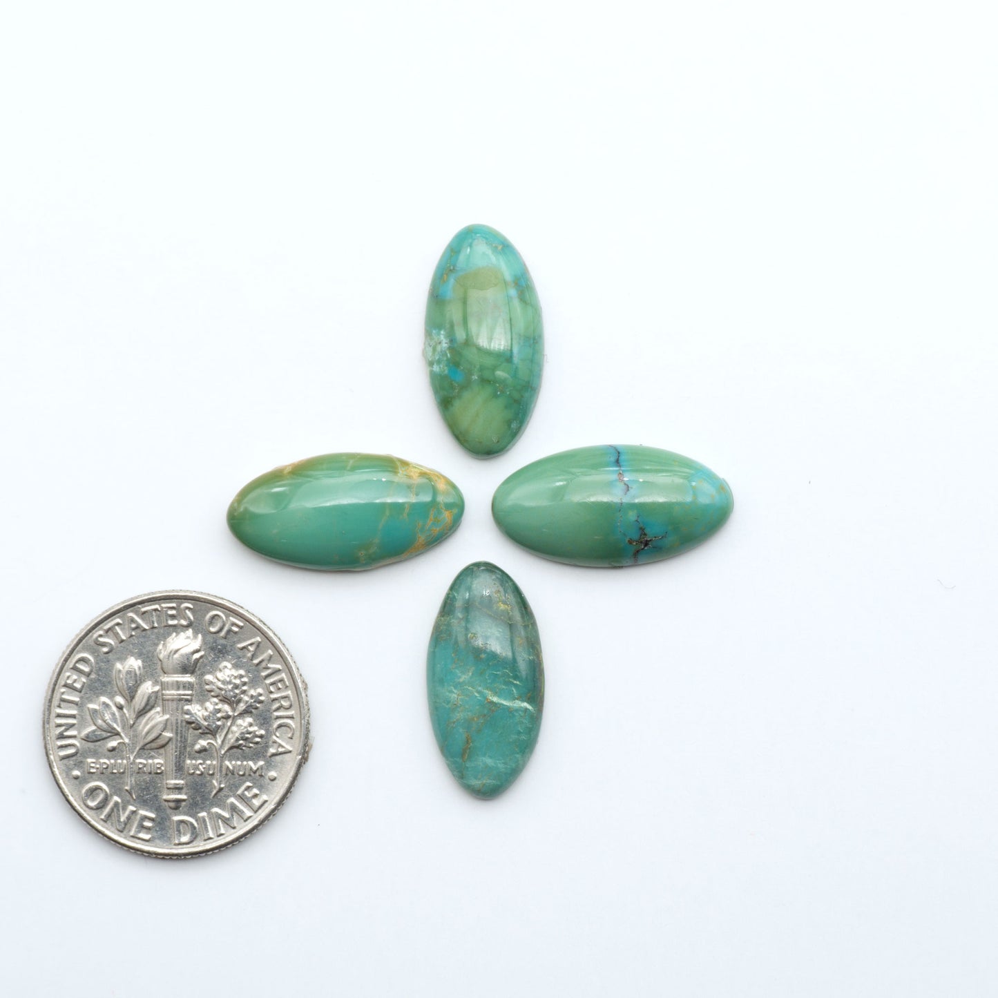 Hubei Cloud Mountain Turquoise cabochons, blue and green color with black matrix, polished stones on a white background, with a US dime for scale
