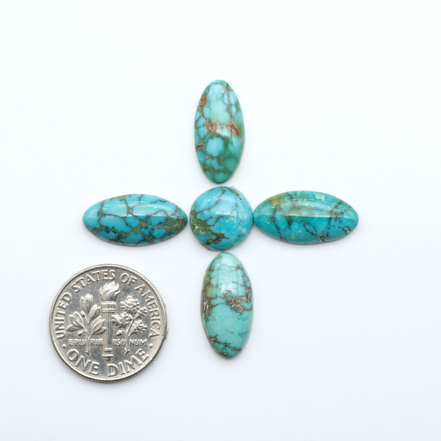 Hubei Cloud Mountain Turquoise cabochons, blue and green color with black matrix, polished stones on a white background, with a US dime for scale