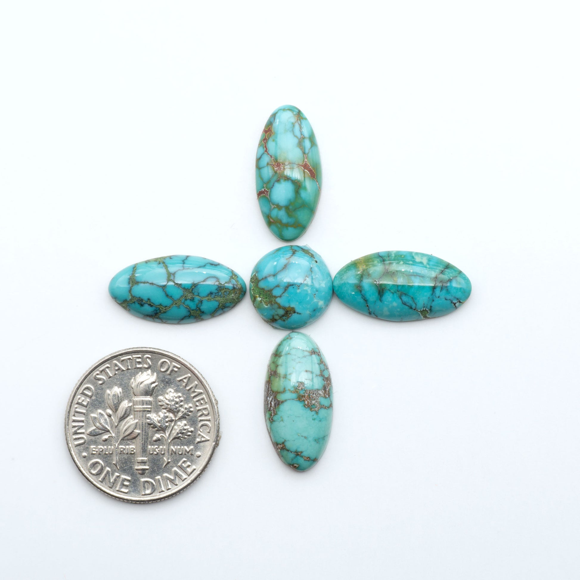 Hubei Cloud Mountain Turquoise cabochons, blue and green color with black matrix, polished stones on a white background, with a US dime for scale