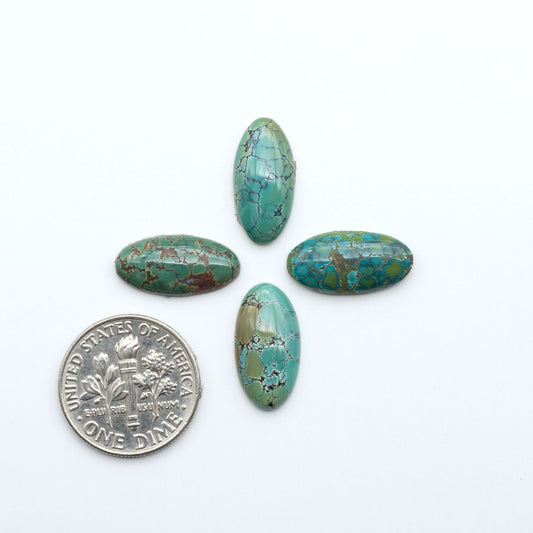 Hubei Cloud Mountain Turquoise cabochons, blue and green color with black matrix, polished stones on a white background, with a US dime for scale