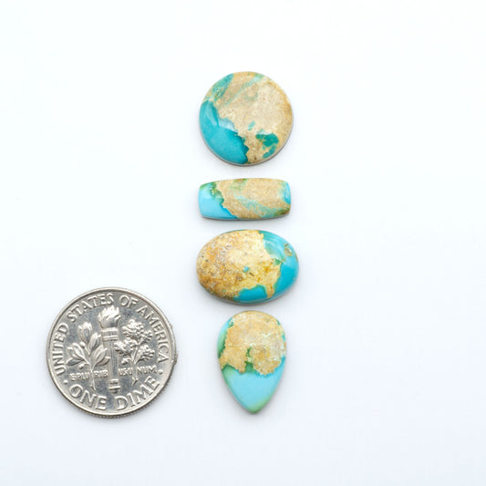 Sonoran Mountain Turquoise cabochons, blue-green color with natural matrix, polished stones on a white background, with a US dime for scale