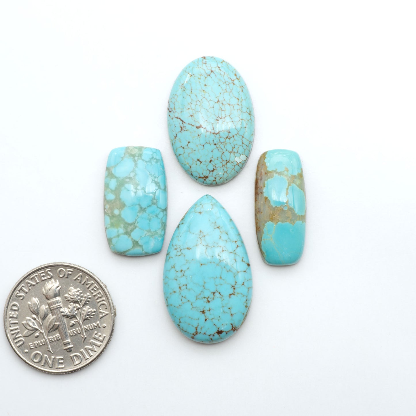 Number 8 Turquoise cabochons, blue and green color with brown matrix, polished stones on a white background, with a US dime for scale