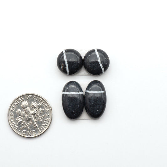 White Buffalo stone cabochons, white stone with black matrix, polished stones on a white background, with a US dime for scale