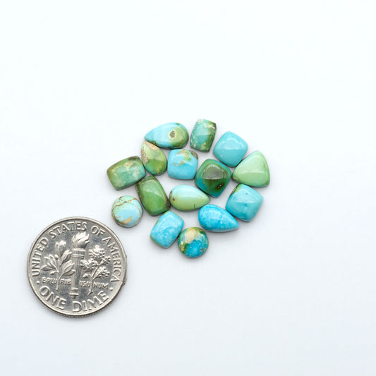 Sonoran Mountain Turquoise cabochons, blue-green color with natural matrix, polished stones on a white background, with a US dime for scale