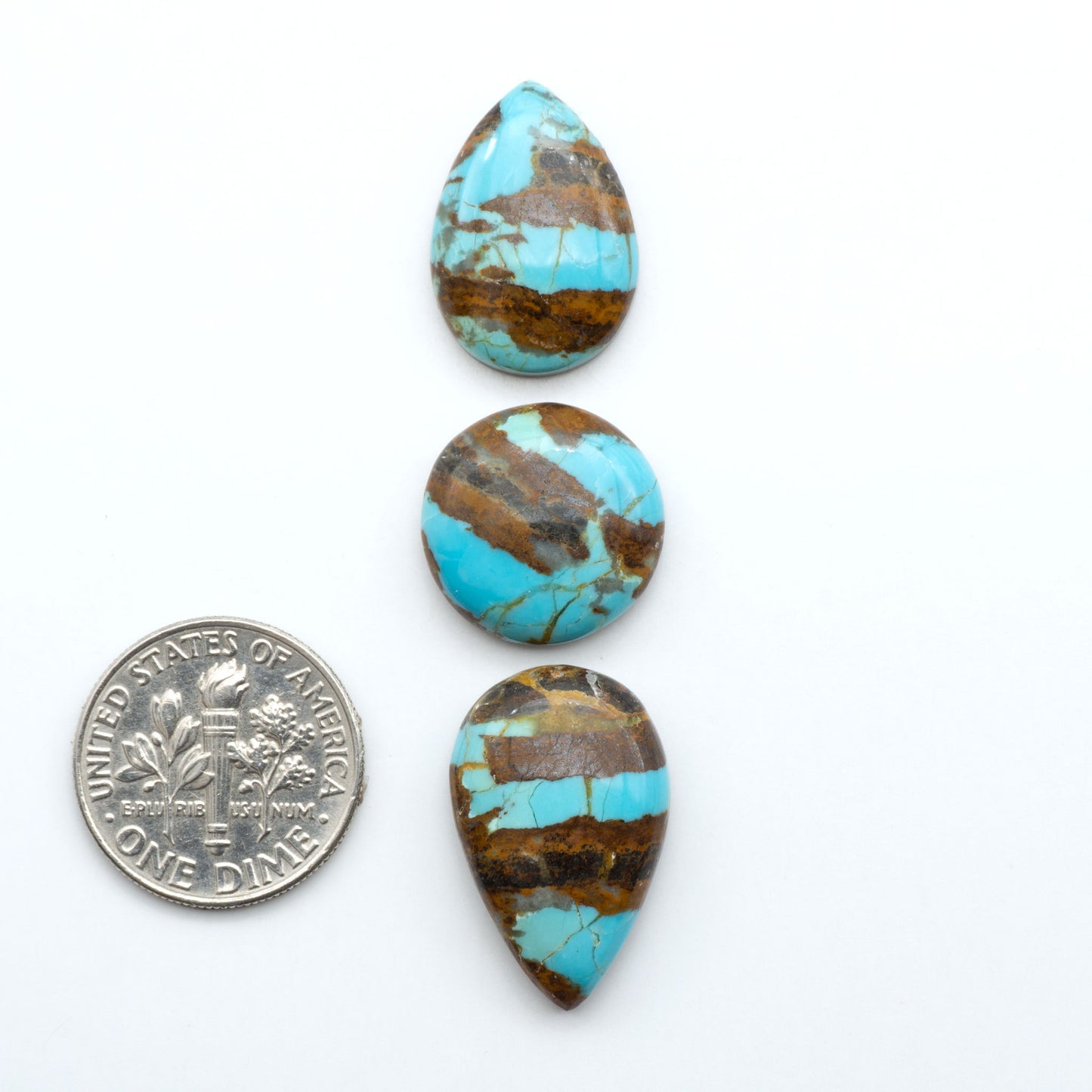 Number 8 Turquoise cabochons, blue and green color with brown matrix, polished stones on a white background, with a US dime for scale