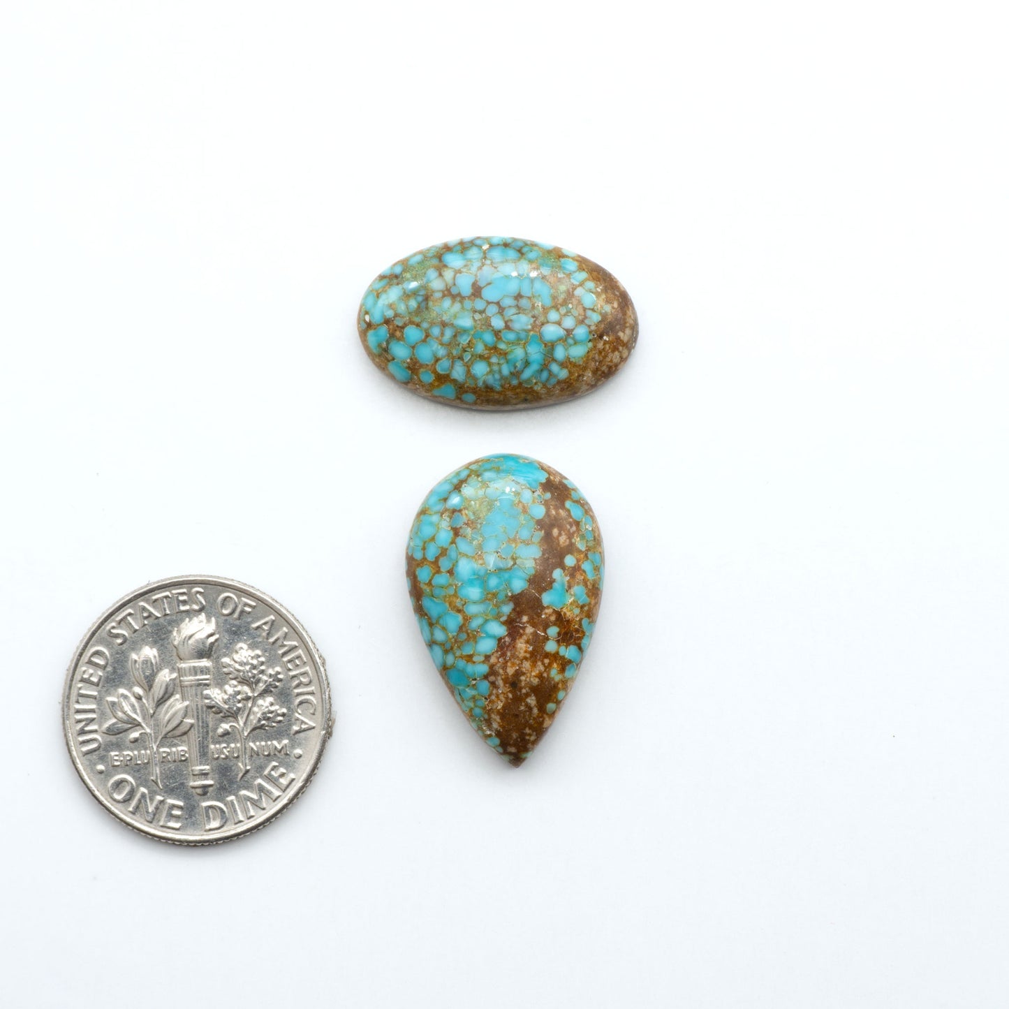 Number 8 Turquoise cabochons, blue and green color with brown matrix, polished stones on a white background, with a US dime for scale
