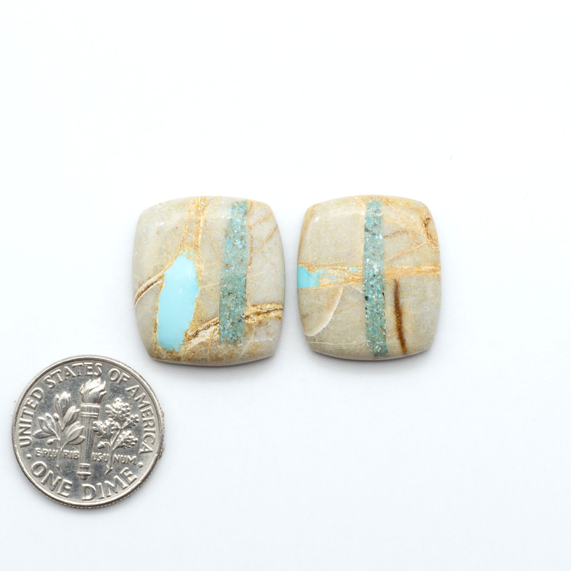 Royston Turquoise cabochons, blue-green color with natural matrix, polished stones on a white background, with a US dime for scale