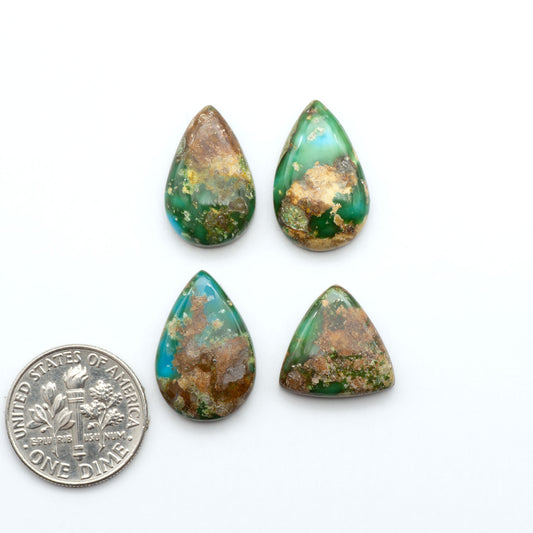 Sonoran Mountain Turquoise cabochons, blue-green color with natural matrix, polished stones on a white background, with a US dime for scale