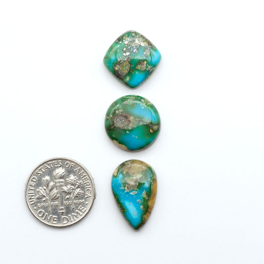 Sonoran Mountain Turquoise cabochons, blue-green color with natural matrix, polished stones on a white background, with a US dime for scale