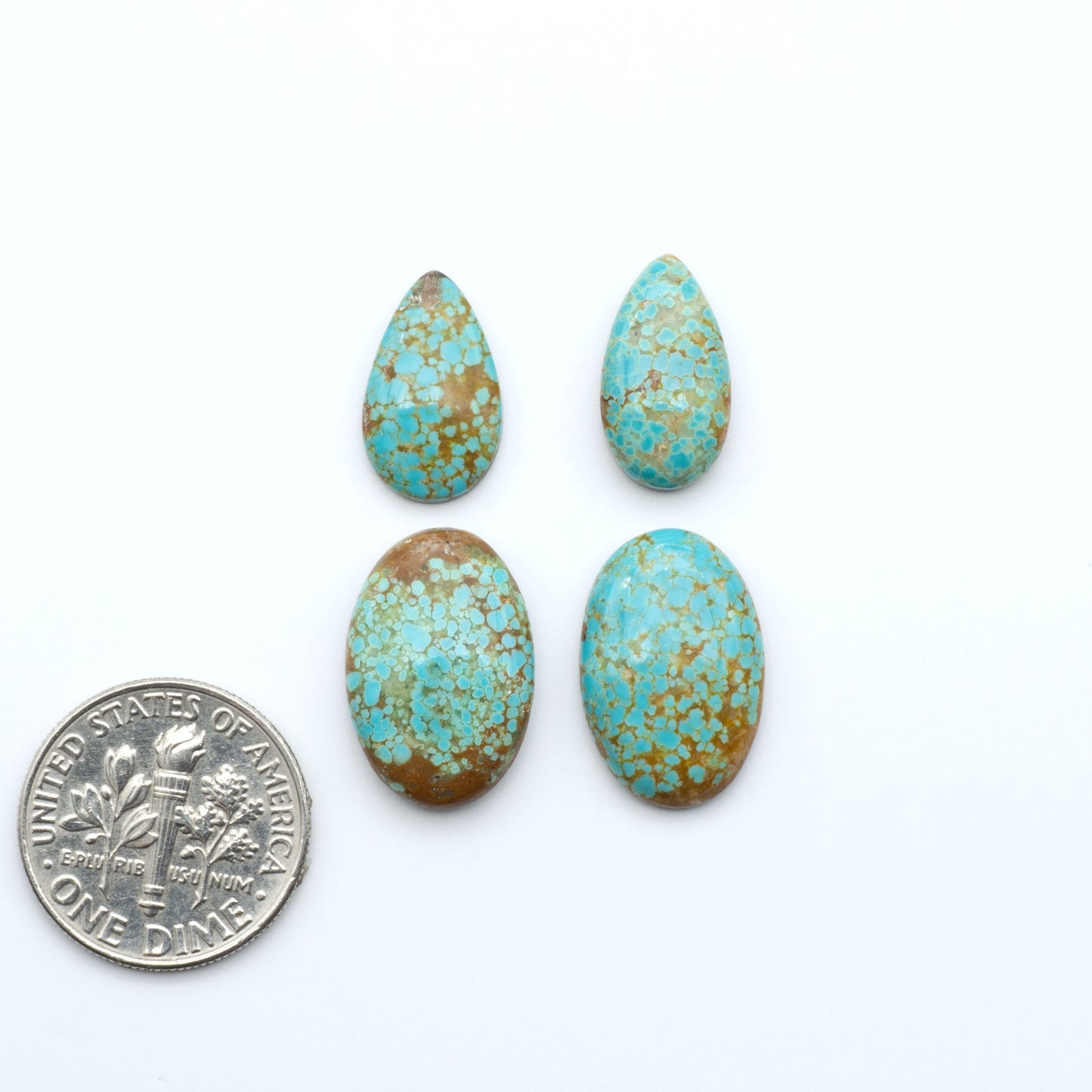 Number 8 Turquoise cabochons, blue and green color with brown matrix, polished stones on a white background, with a US dime for scale