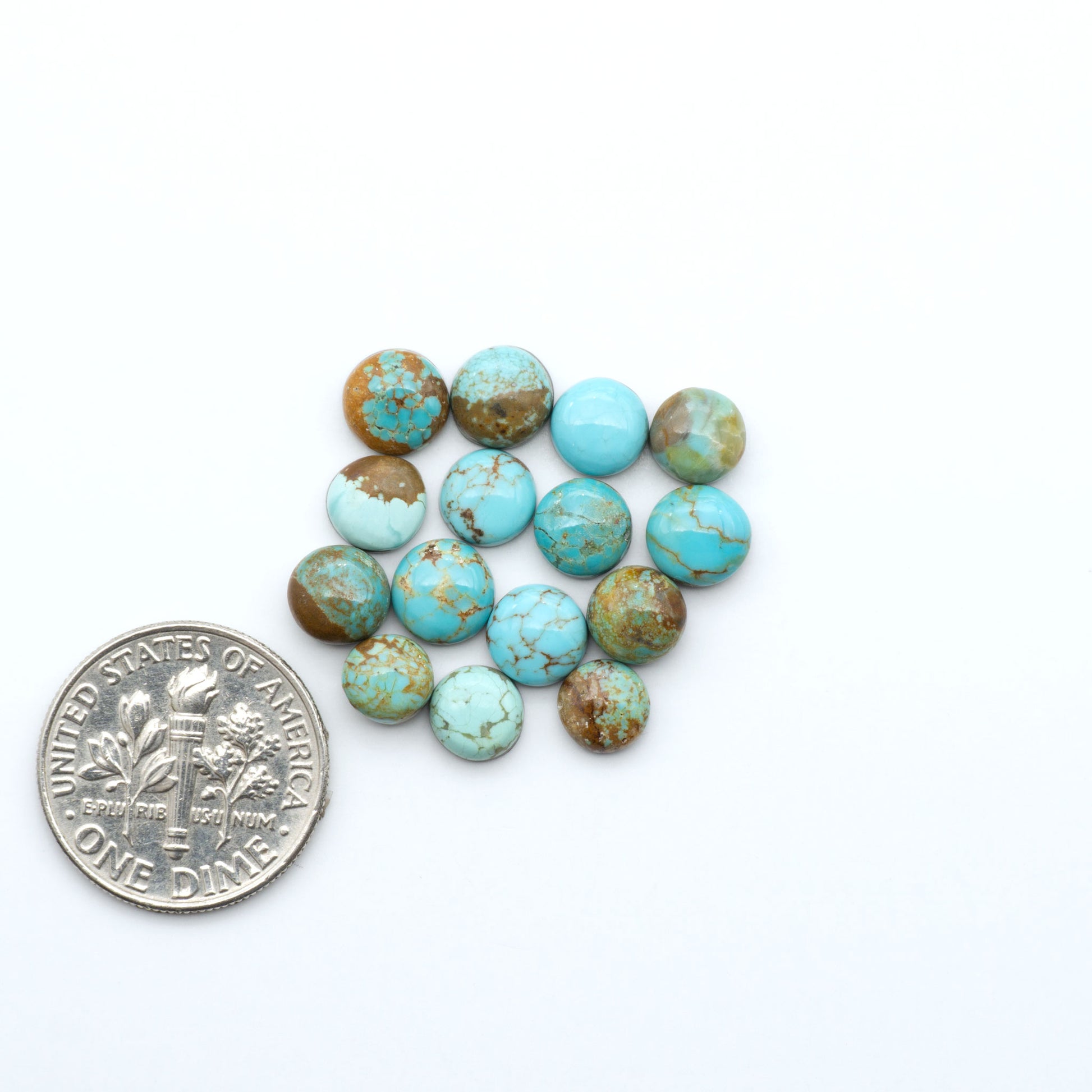Number 8 Turquoise cabochons, blue and green color with brown matrix, polished stones on a white background, with a US dime for scale
