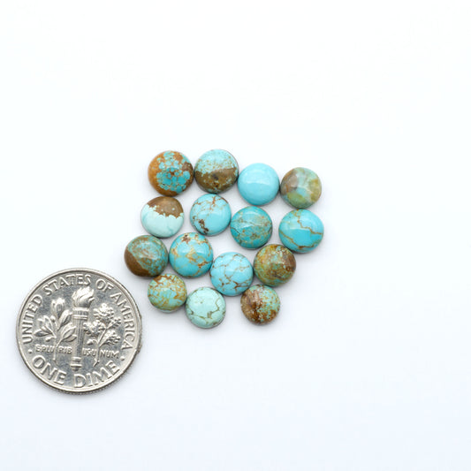 Number 8 Turquoise cabochons, blue and green color with brown matrix, polished stones on a white background, with a US dime for scale