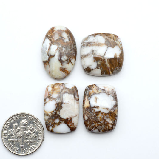 Wild Horse Magnesite cabochons, white gemstones with brown matrix on a white background, with a US dime for scale