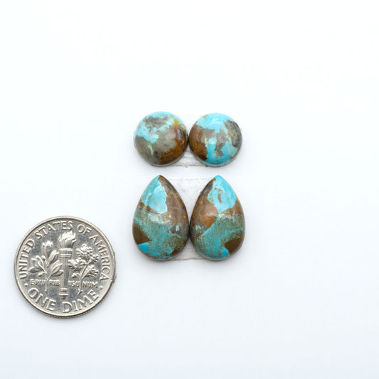 Number 8 Turquoise cabochons, blue and green color with brown matrix, polished stones on a white background, with a US dime for scale