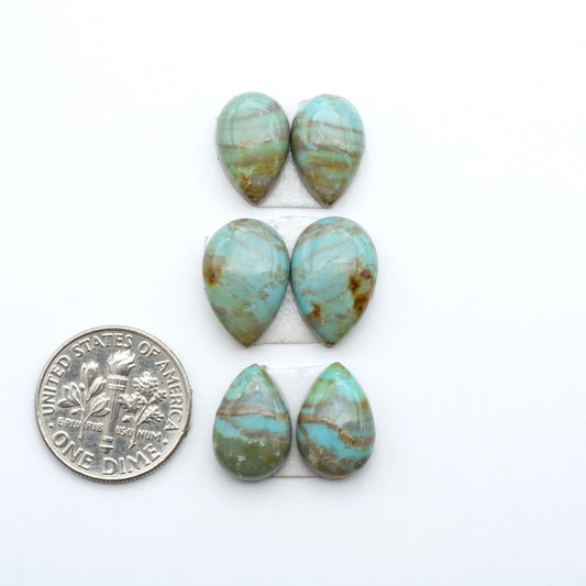 Number 8 Turquoise cabochons, blue and green color with brown matrix, polished stones on a white background, with a US dime for scale