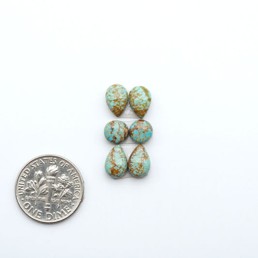 Number 8 Turquoise cabochons, blue and green color with brown matrix, polished stones on a white background, with a US dime for scale