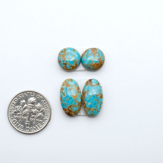 Number 8 Turquoise cabochons, blue and green color with brown matrix, polished stones on a white background, with a US dime for scale