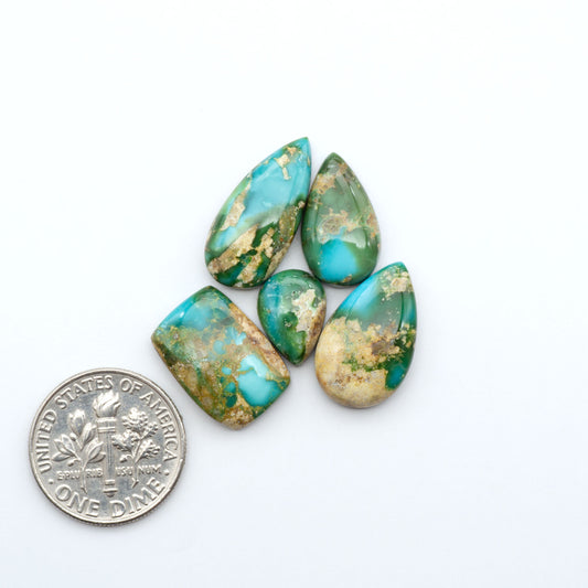 Sonoran Mountain Turquoise cabochons, blue-green color with natural matrix, polished stones on a white background, with a US dime for scale