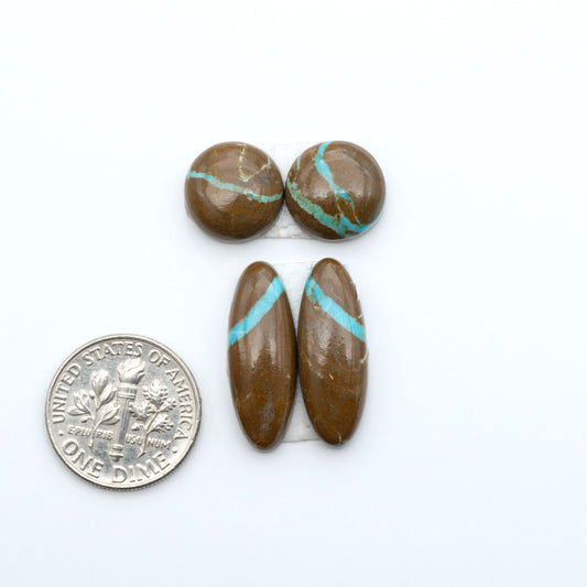 Number 8 Turquoise cabochons, blue and green color with brown matrix, polished stones on a white background, with a US dime for scale