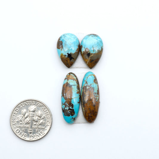 Number 8 Turquoise cabochons, blue and green color with brown matrix, polished stones on a white background, with a US dime for scale