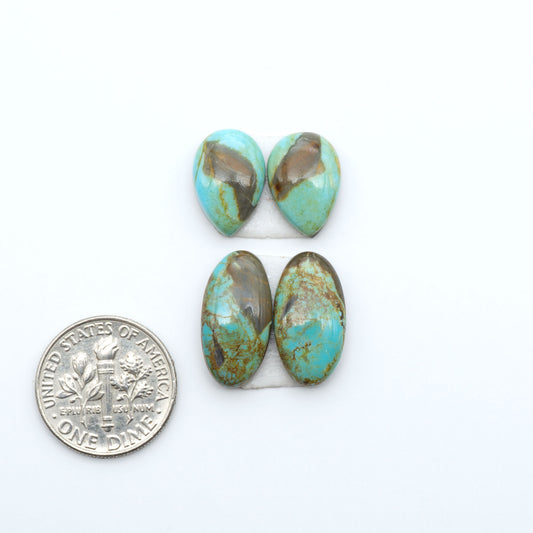 Number 8 Turquoise cabochons, blue and green color with brown matrix, polished stones on a white background, with a US dime for scale