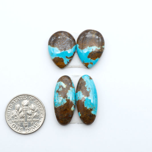 Number 8 Turquoise cabochons, blue and green color with brown matrix, polished stones on a white background, with a US dime for scale