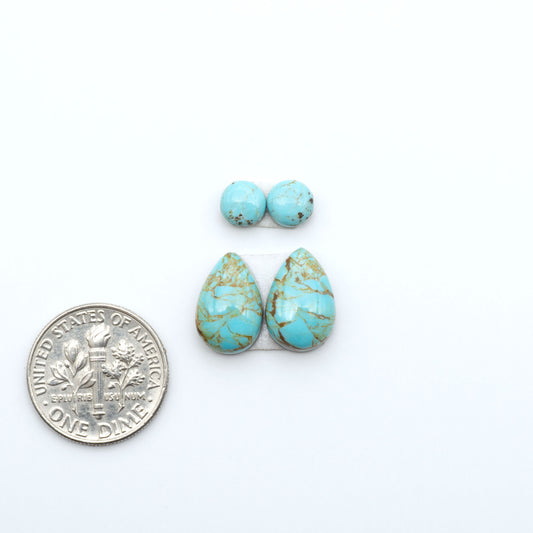 Number 8 Turquoise cabochons, blue and green color with brown matrix, polished stones on a white background, with a US dime for scale