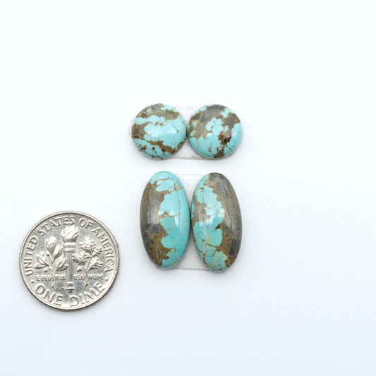 Number 8 Turquoise cabochons, blue and green color with brown matrix, polished stones on a white background, with a US dime for scale