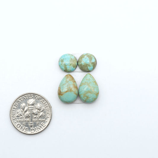 Number 8 Turquoise cabochons, blue and green color with brown matrix, polished stones on a white background, with a US dime for scale