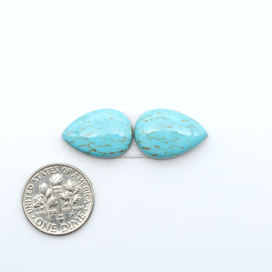 Number 8 Turquoise cabochons, blue and green color with brown matrix, polished stones on a white background, with a US dime for scale