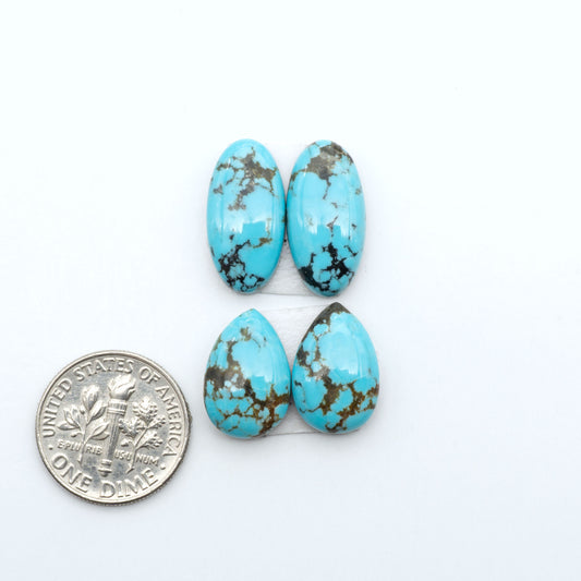 Number 8 Turquoise cabochons, blue and green color with brown matrix, polished stones on a white background, with a US dime for scale