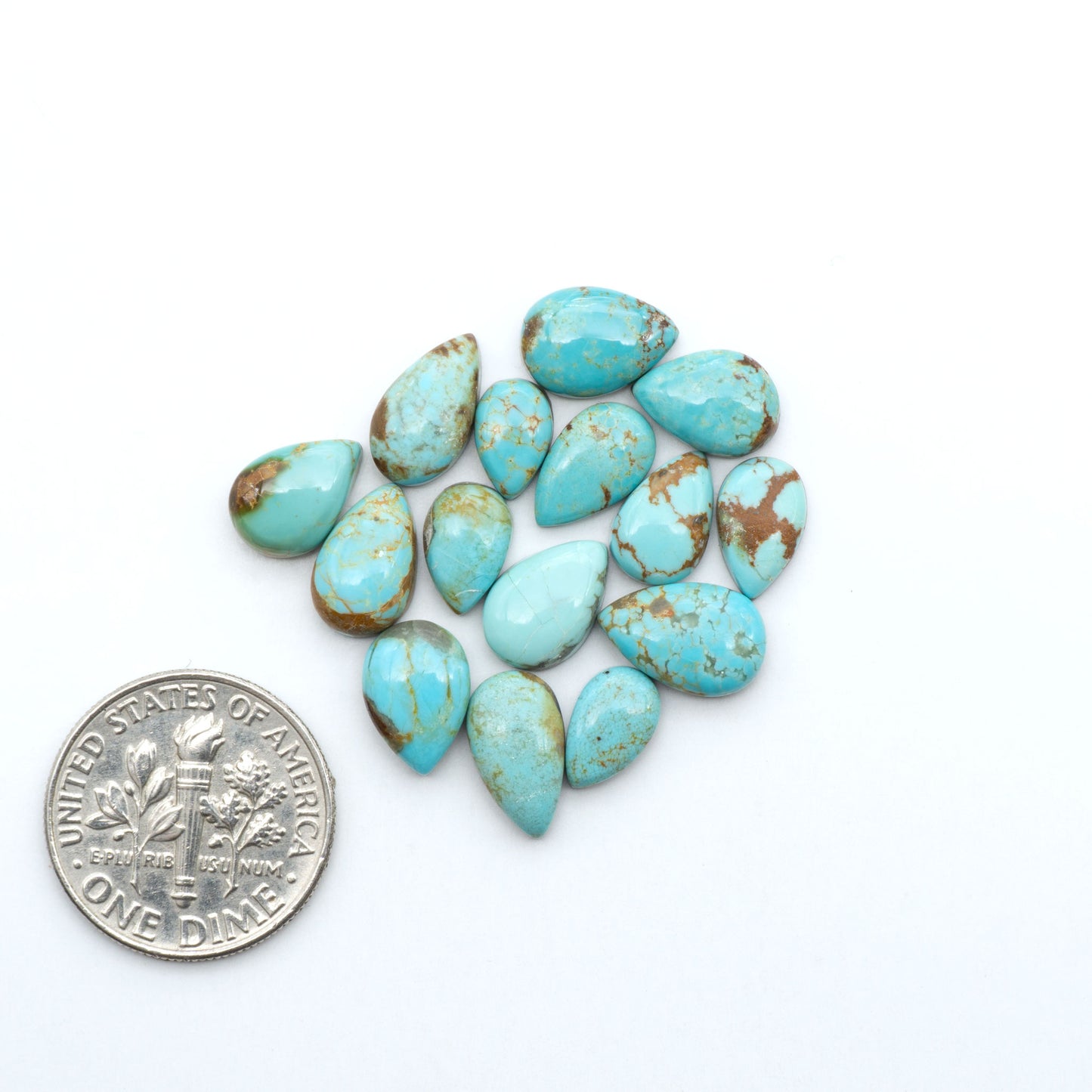 Number 8 Turquoise cabochons, blue and green color with brown matrix, polished stones on a white background, with a US dime for scale