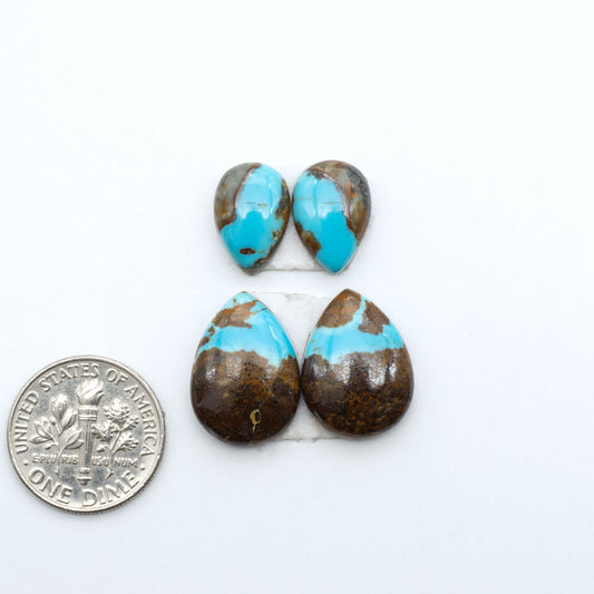 Number 8 Turquoise cabochons, blue and green color with brown matrix, polished stones on a white background, with a US dime for scale