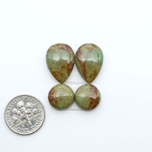 Number 8 Turquoise cabochons, blue and green color with brown matrix, polished stones on a white background, with a US dime for scale