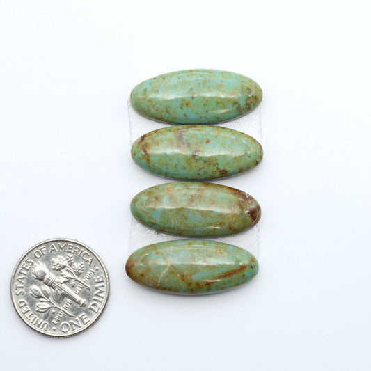 Number 8 Turquoise cabochons, blue and green color with brown matrix, polished stones on a white background, with a US dime for scale
