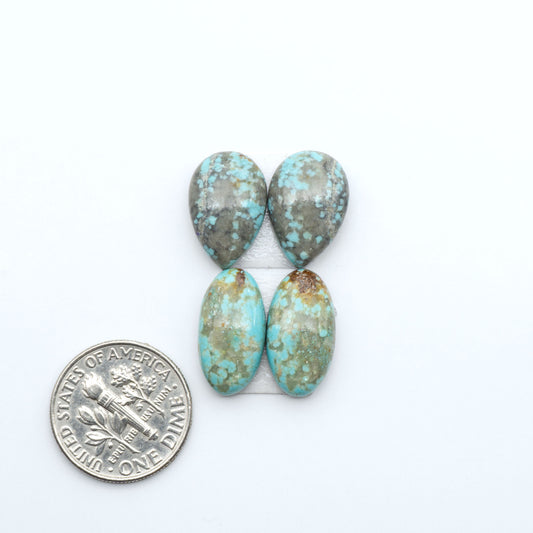Number 8 Turquoise cabochons, blue and green color with brown matrix, polished stones on a white background, with a US dime for scale