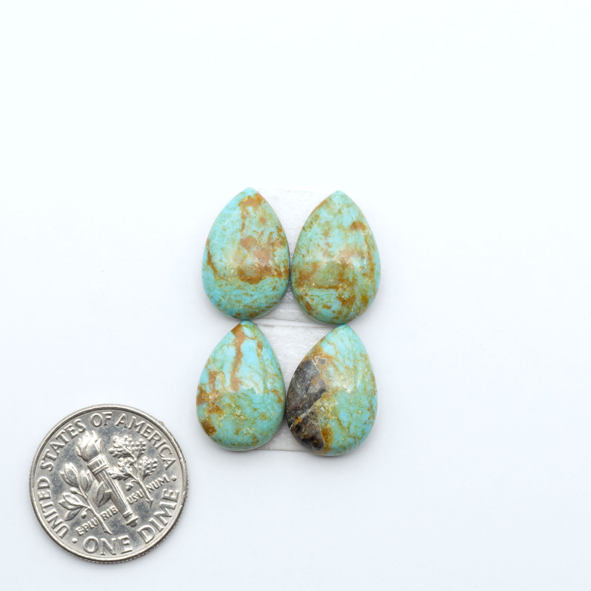 Number 8 Turquoise cabochons, blue and green color with brown matrix, polished stones on a white background, with a US dime for scale