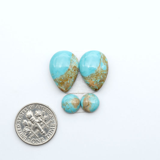 Number 8 Turquoise cabochons, blue and green color with brown matrix, polished stones on a white background, with a US dime for scale