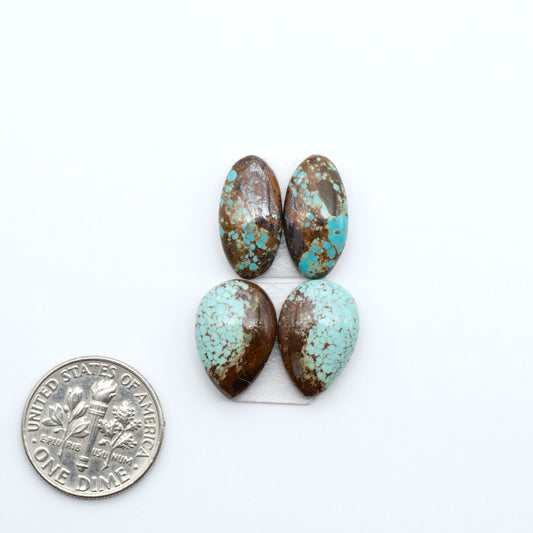 Number 8 Turquoise cabochons, blue and green color with brown matrix, polished stones on a white background, with a US dime for scale
